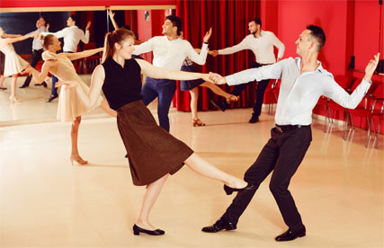 Couples Practicing Swing Dance in Studio